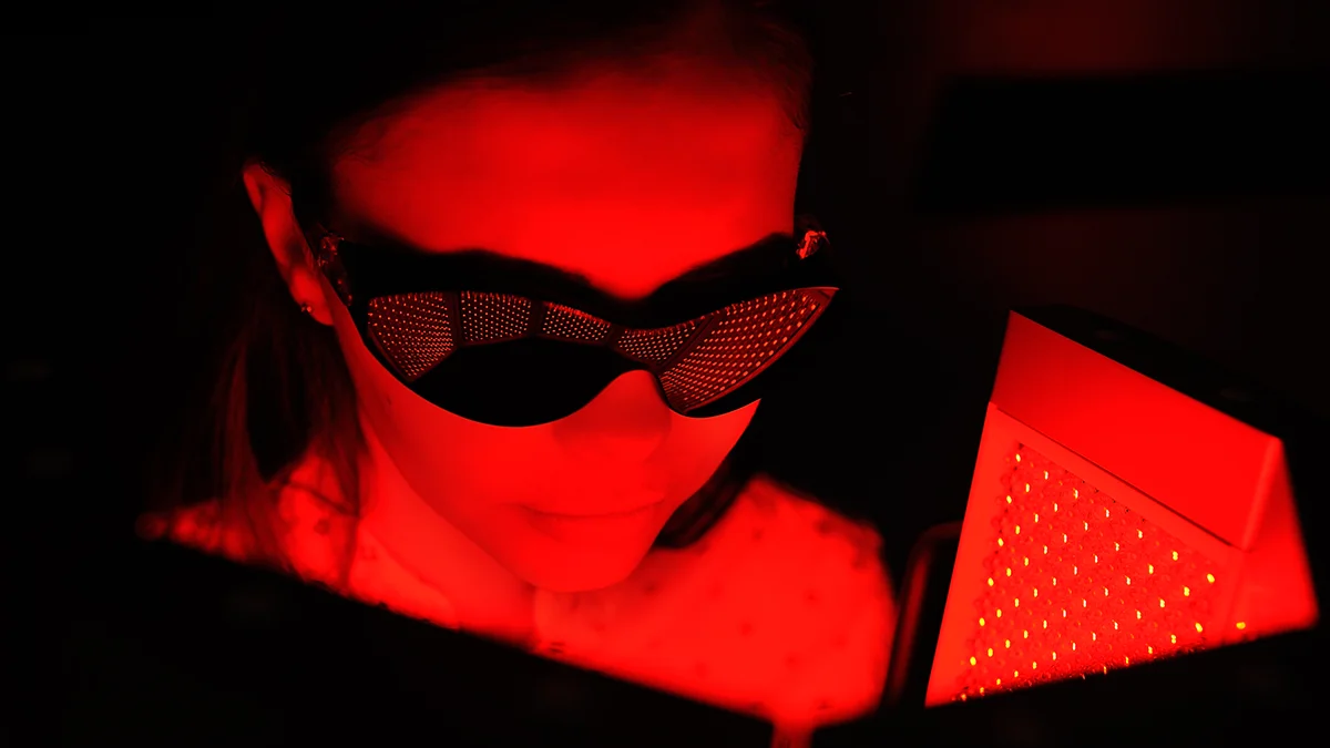 a woman with goggles protecting eyes during red light therapy
